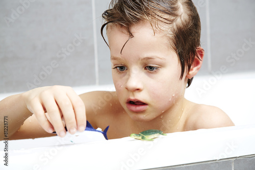 Boy in bath playing