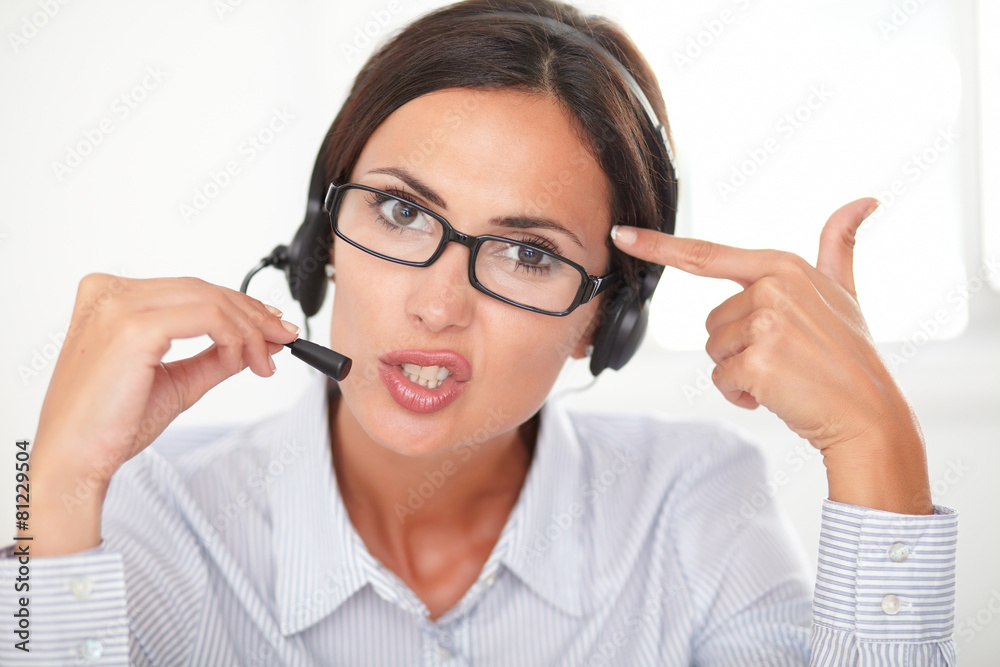 Confident pretty woman conversing on headset Confident pretty woman conversing on headset
