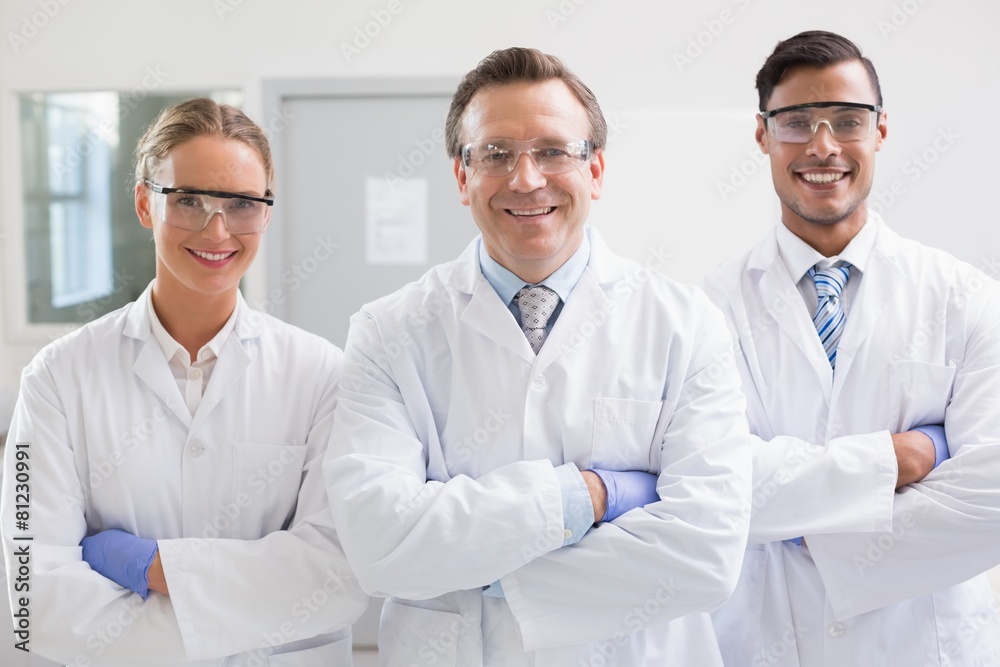Smiling scientists looking at camera arms crossed Smiling scientists looking at camera arms crossed