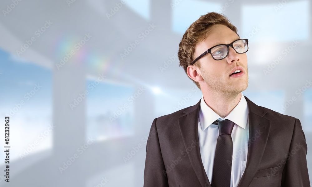 Composite image of young businessman thinking and looking up Composite image of young businessman thinking and looking up