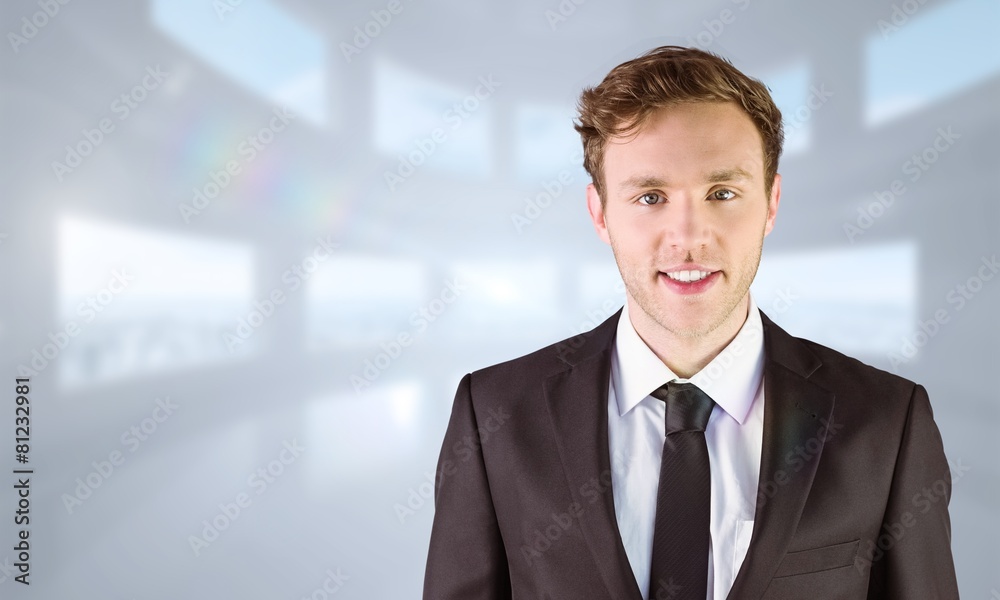 Composite image of young businessman smiling at camera Composite image of young businessman smiling at camera