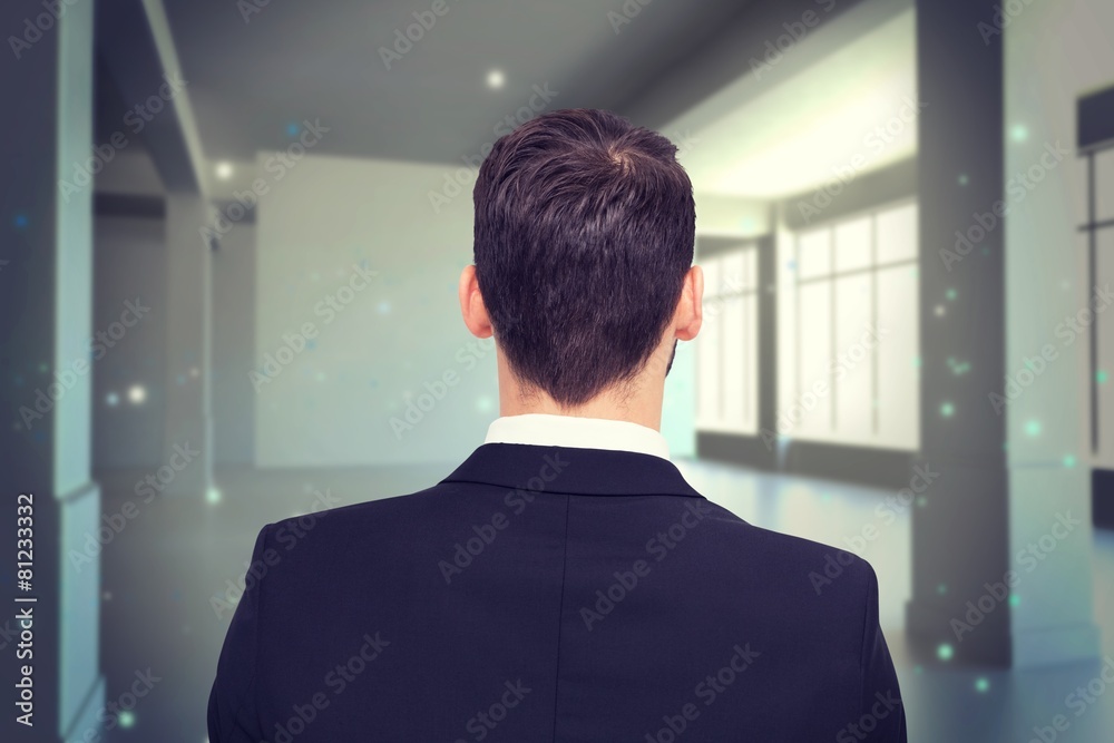 Composite image of rear view of businessman in suit standing Composite image of rear view of businessman in suit standing