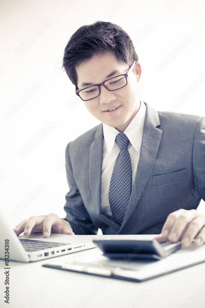 Handsome businessman working with laptop Handsome businessman working with laptop