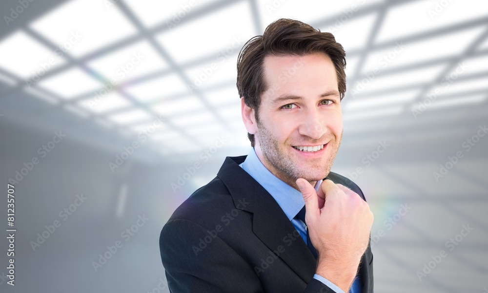 businessman touching his chin while smiling at camera businessman touching his chin while smiling at camera