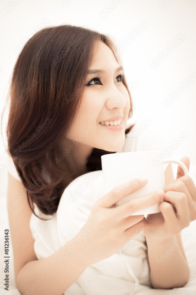 Portrait of a beautiful young woman in bed