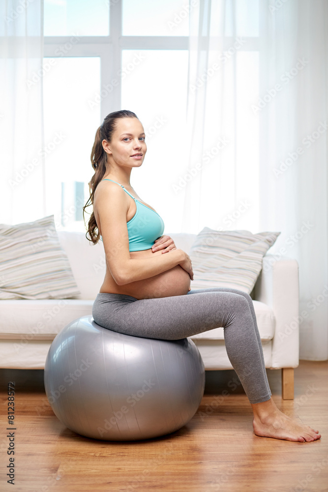 happy pregnant woman exercising on fitball at home happy pregnant woman exercising on fitball at home