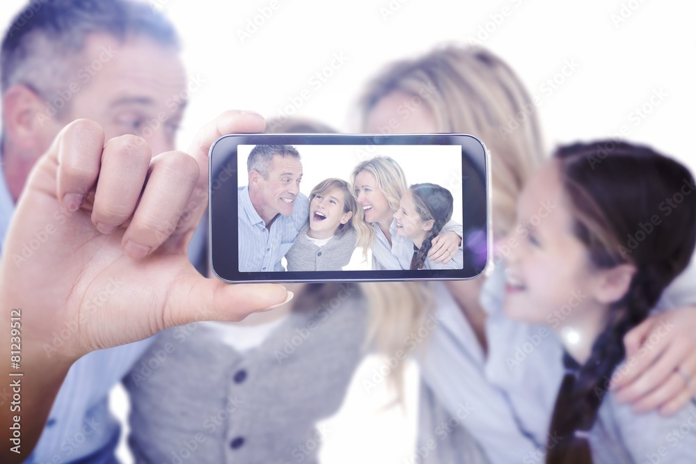 Composite image of hand holding smartphone showing