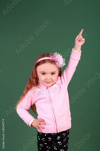 little girl pointing upward