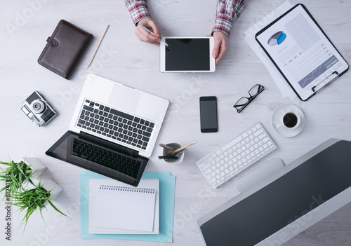 Businessman working at desk with a digital tablet