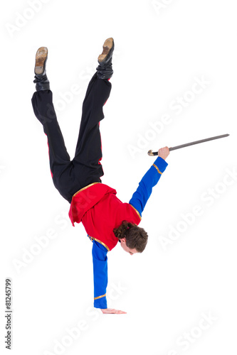 Russian cossack dance. Young dancer posing with sword photo