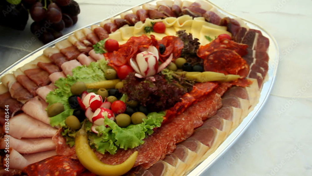 Arranged plate with salami, sausages, cheese, salad Arranged plate with salami, sausages, cheese, salad