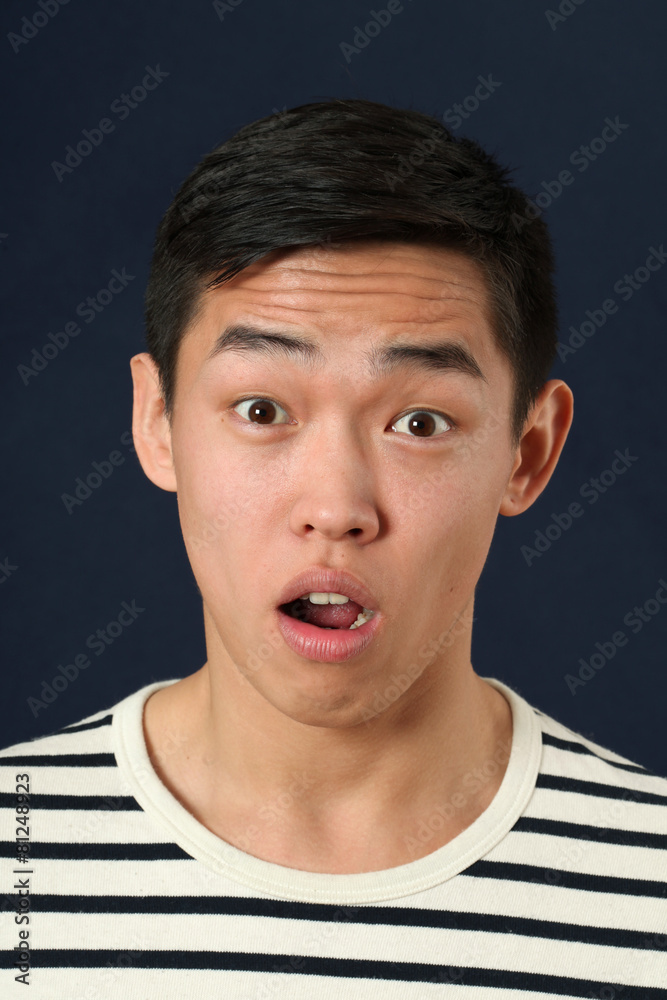 Disappointed young Asian man looking at camera Disappointed young Asian man looking at camera