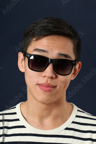 Smiling young Asian man in sunglasses © Vladimir Wrangel