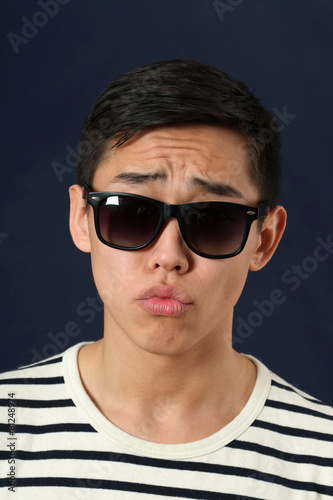Disappointed young Asian man in sunglasses © Vladimir Wrangel