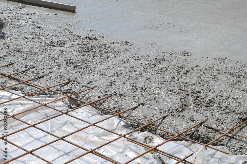 Wet concrete cement flowing over rebar metal - obrazy, fototapety, plakaty 