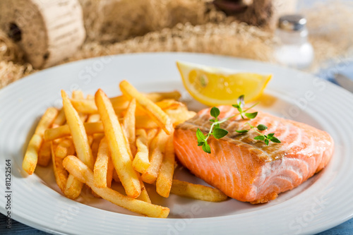 Delicious salmon with chips with lemon