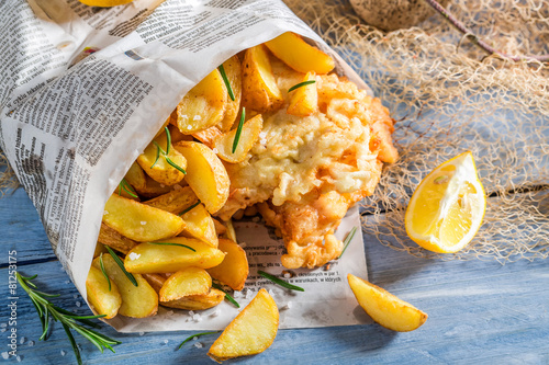 Photography Delicious fish cod with chips with lemon
