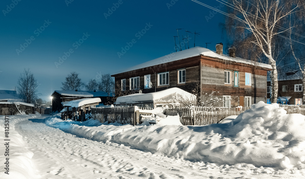 old wooden barracks at winter night