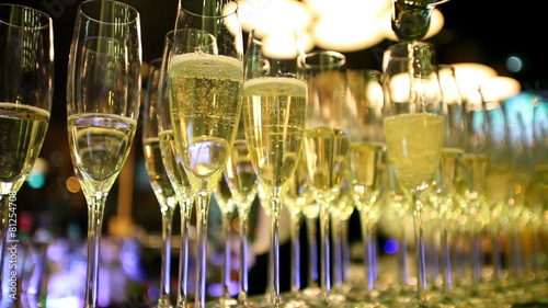 Glasses filled with champagne on bar counter