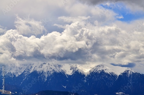 Big clouds on top of Bucegi mountain peak in winter season