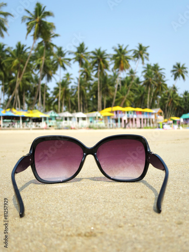 Sunglasses on the sand of Palolem beach. South Goa, India