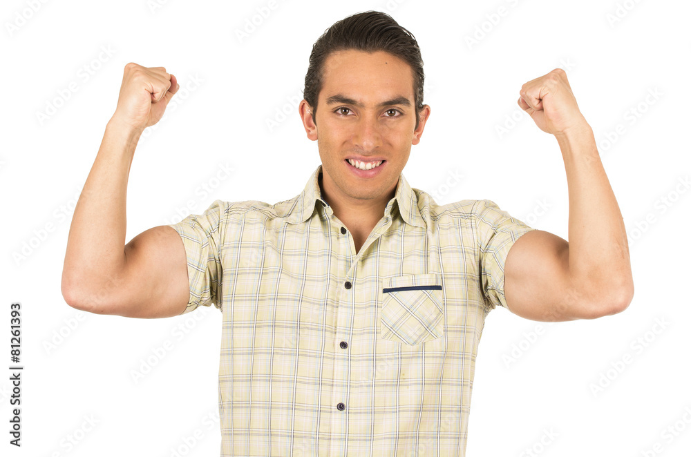 young handsome hispanic man posing showing arm muscles young handsome hispanic man posing showing arm muscles