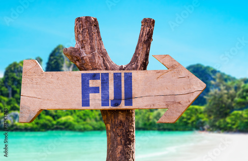 Fiji wooden sign with beach background photo