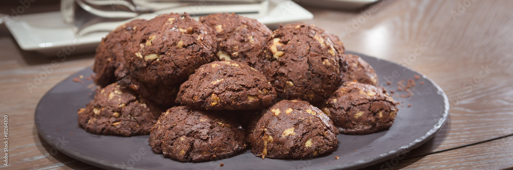 Chocolate and nut cookies on wooden table Chocolate and nut cookies on wooden table