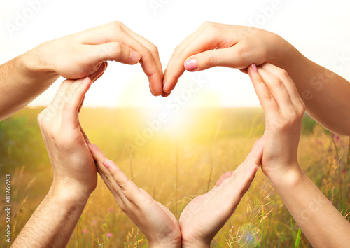 Heart shaped by hands on nature background