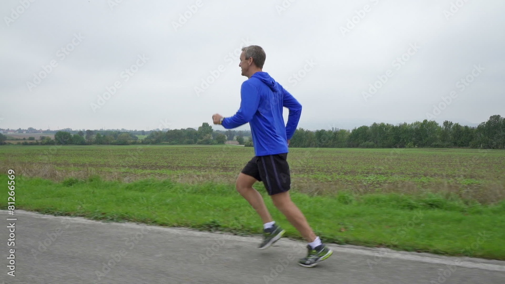 slow motion man jogging on cloudy day