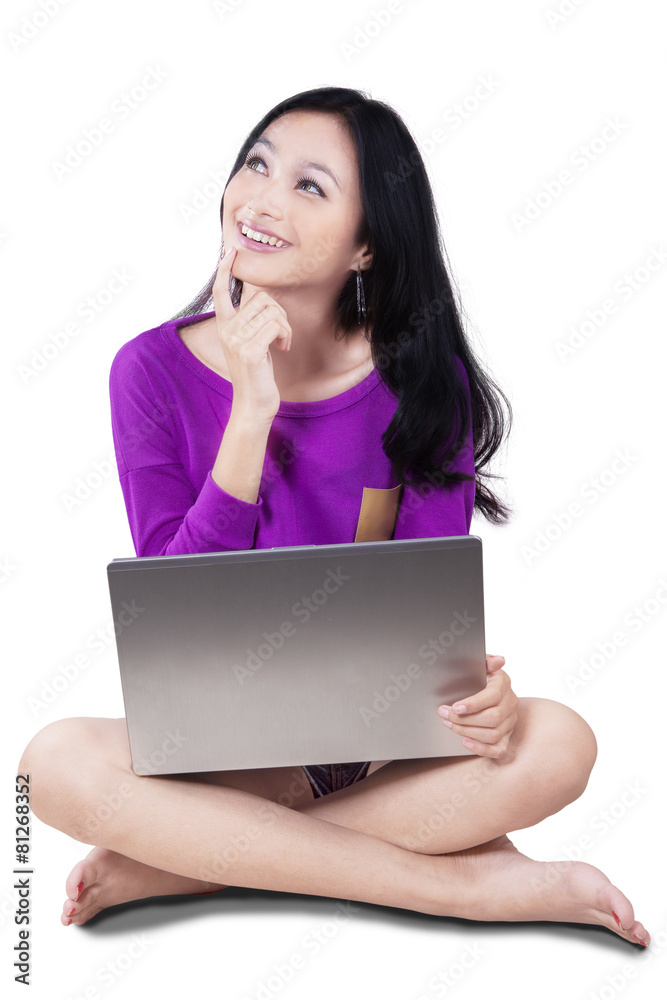 Cheerful student with laptop searching idea Cheerful student with laptop searching idea