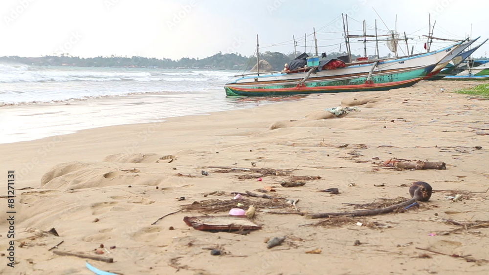 WELIGAMA, SRI LANKA - MARCH 2014: View of wooden fishing boats on beach. The term Weligama literally means WELIGAMA, SRI LANKA - MARCH 2014: View of wooden fishing boats on beach. The term Weligama literally means