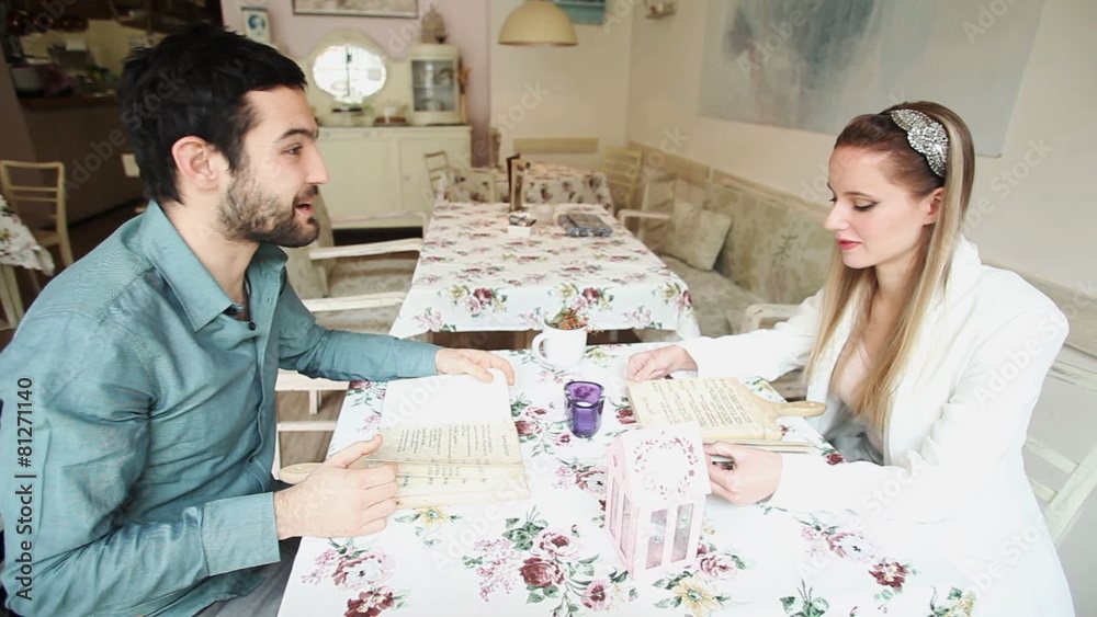Couple in restaurant reading menus Couple in restaurant reading menus