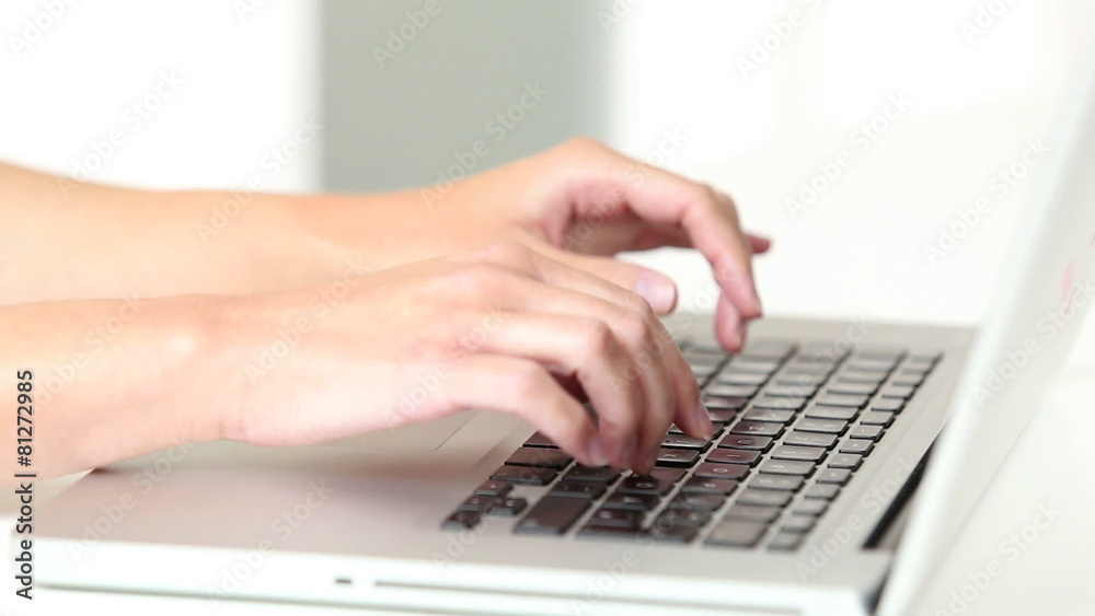 Woman’s hands typing on laptop keyboard Woman’s hands typing on laptop keyboard