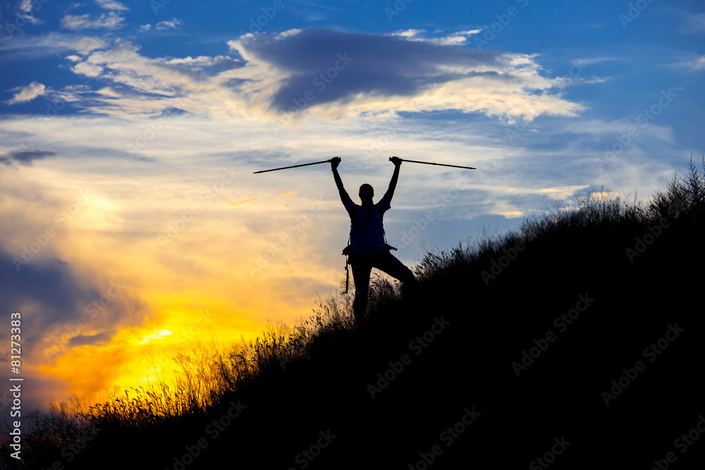 Silhouette of human on the summit against colorful sunset