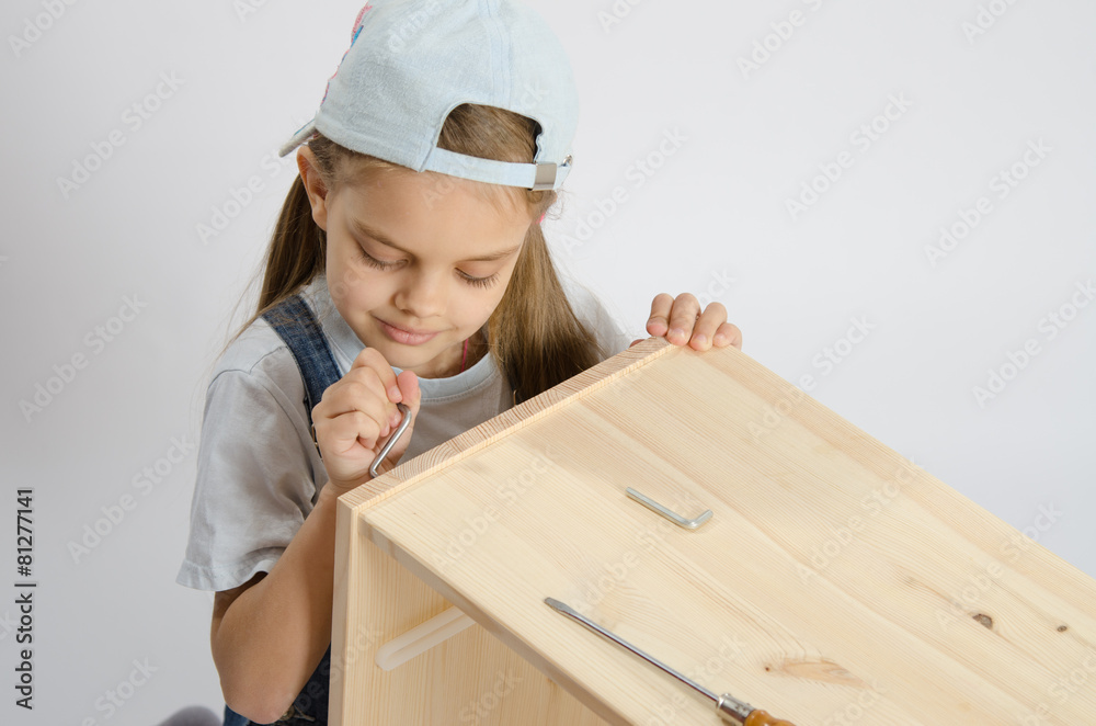 Little girl in the image of garbage furniture screw spins Little girl in the image of garbage furniture screw spins