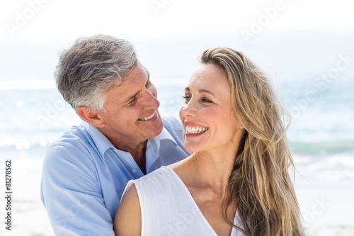 Happy couple smiling at each other by the sea © WavebreakMediaMicro