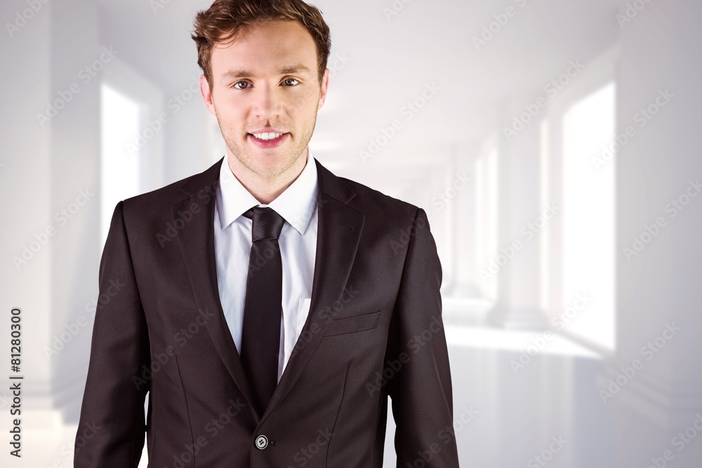 Composite image of young businessman smiling at camera Composite image of young businessman smiling at camera