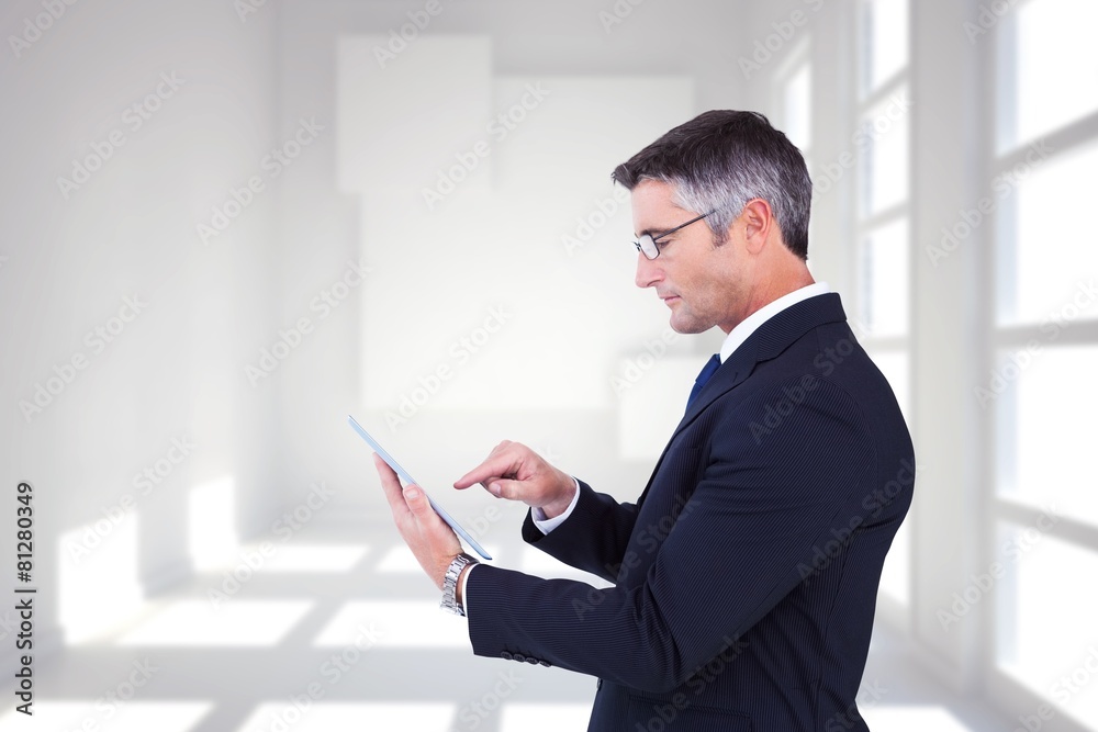 Composite image of mid section of a businessman touching tablet Composite image of mid section of a businessman touching tablet