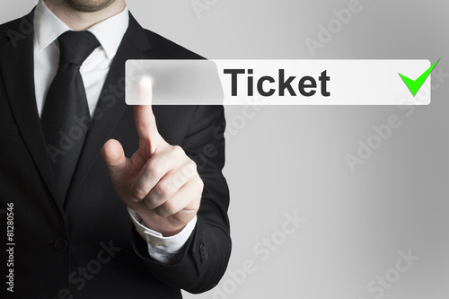 businessman pushing button ticket