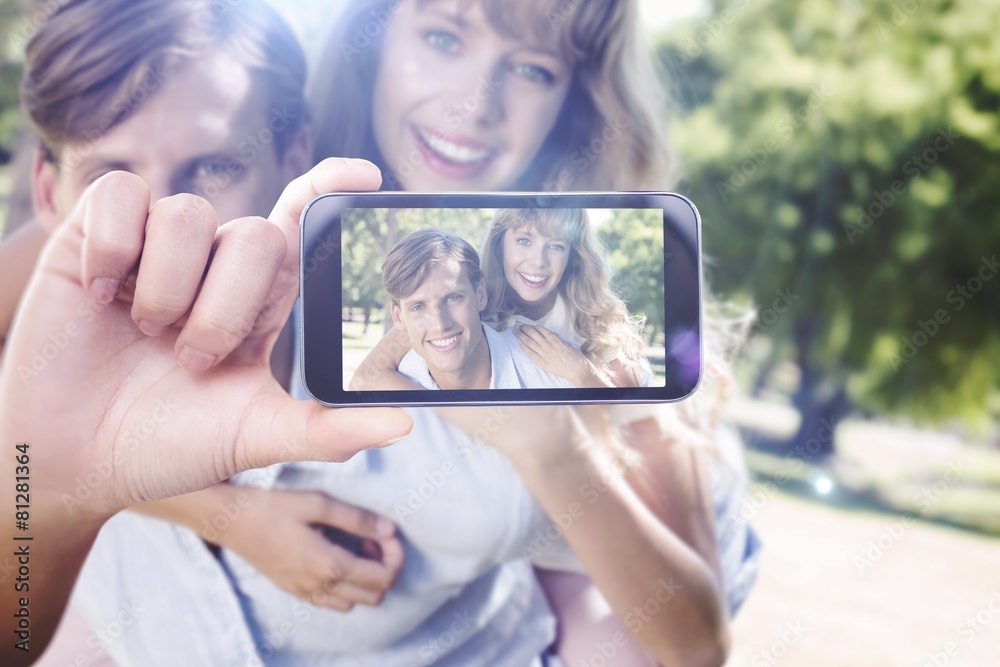 Composite image of hand holding smartphone showing