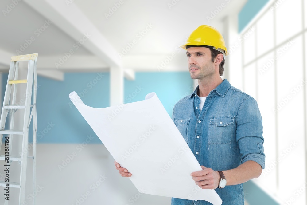 Composite image of architect holding blueprint in house Composite image of architect holding blueprint in house