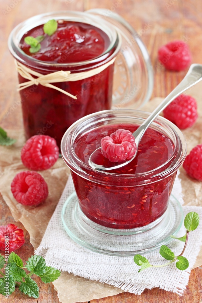 Homemade delicious raspberry jam on a rustic wooden table Homemade delicious raspberry jam on a rustic wooden table