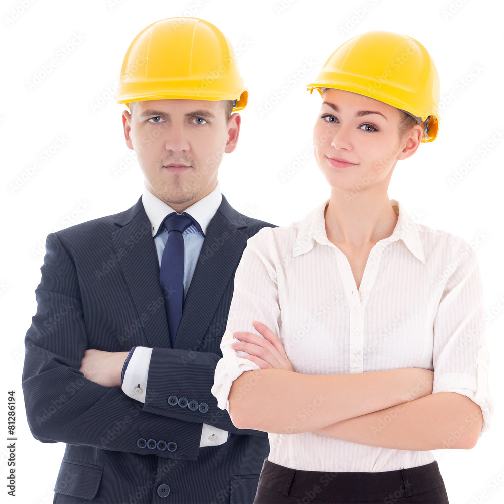 young man and woman in builder 's helmets isolated on white young man and woman in builder 's helmets isolated on white