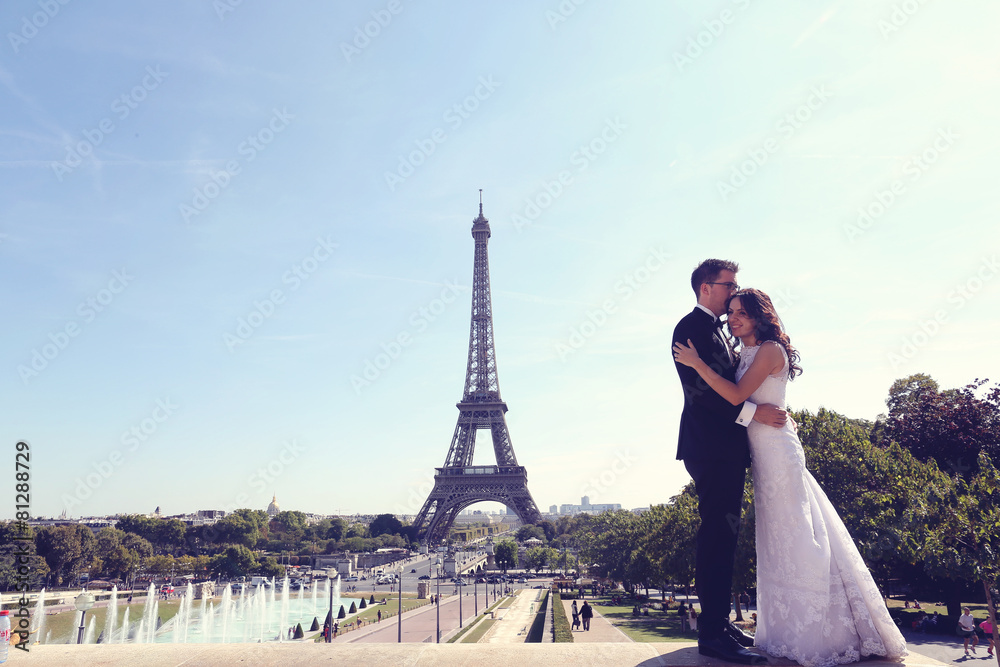 Bride and groom embracing in Paris