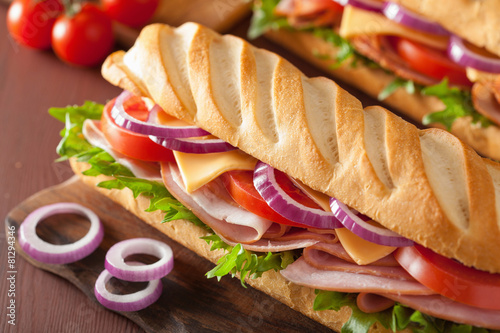 long baguette sandwich with ham cheese tomato lettuce