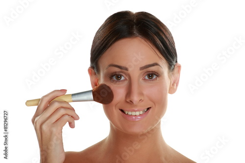 beautiful young woman holding make-up brushes