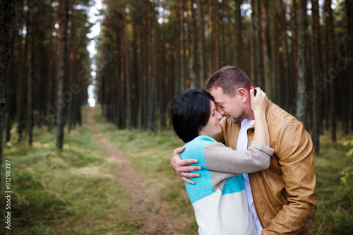 Happy couple in a pine forest