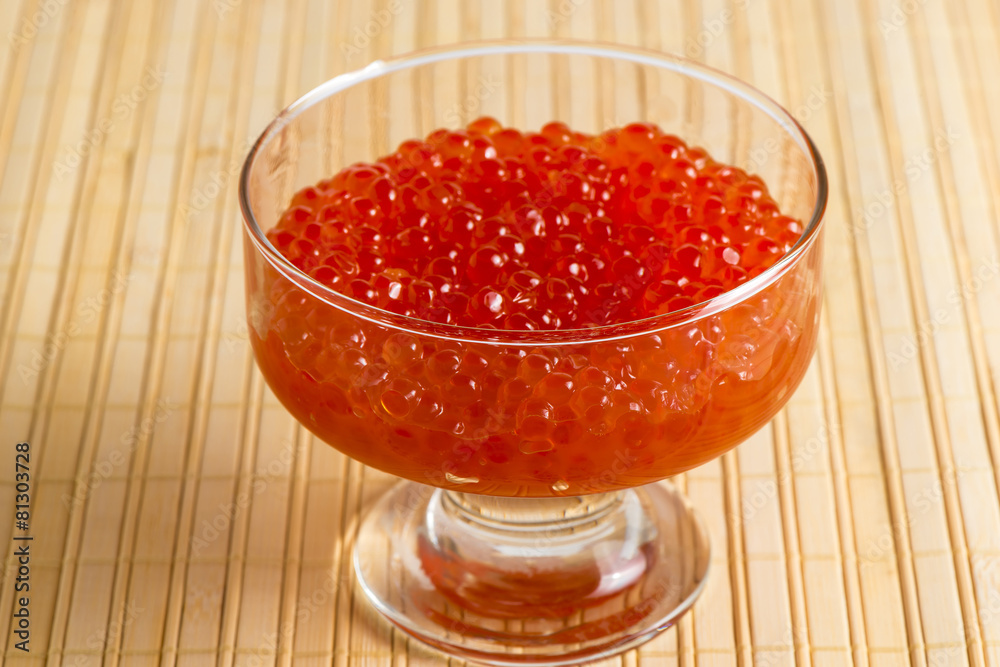 bowl with red caviar on a bamboo napkin bowl with red caviar on a bamboo napkin