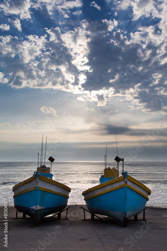 Row of old fishing boats in small harbour next to the ocean in t © Alta Oosthuizen